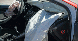 Deployed airbags on driver and passenger sides after a collision