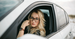 Teenage girl driving a white car