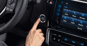 Driver's finger ready to press the key-less ignition button