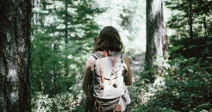 Young woman walking along a forest trail