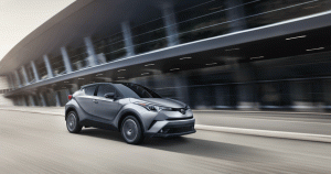 Silver Toyota C-HR driving through city streets